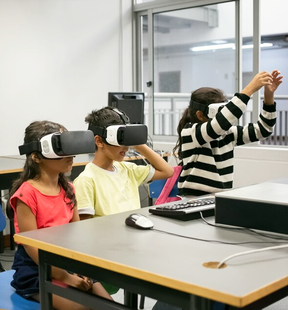 Students using virtual reality headsets in a classroom for immersive, interactive learning experiences