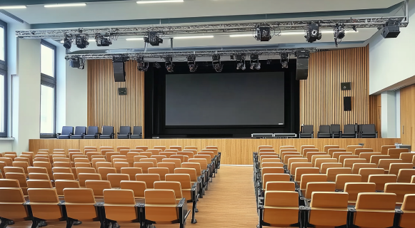 Modern auditorium with with Large LED wall on stage and and stage lighting setups