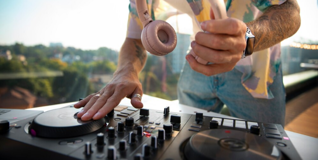 A DJ playing music with the DJ Mixer