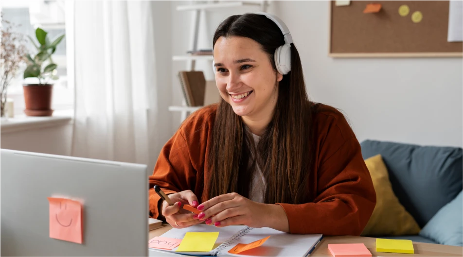 Student attending remote learning session with headphones and laptop, engaging in online education from home
