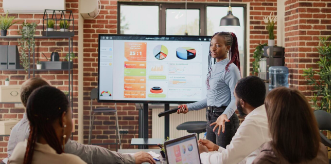 A woman presenting using wireless presentation technology