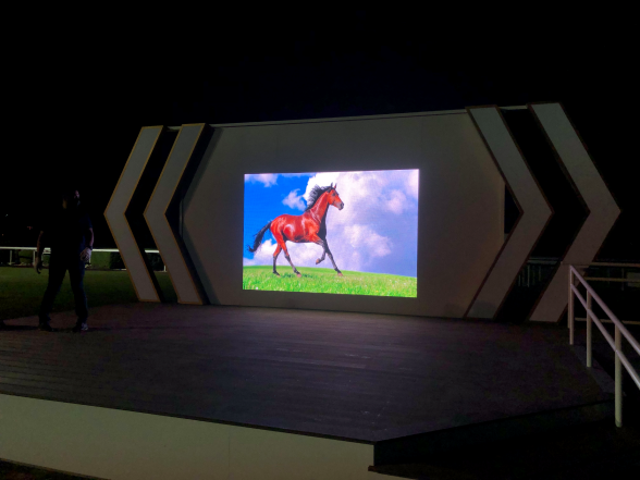 Large outdoor LED screen displaying vivid visuals on stage platform designed for stadium and arena AV use
