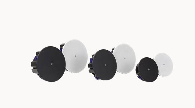 Black and white ceiling mounted background music speakers arranged in a row for retail store audio systems