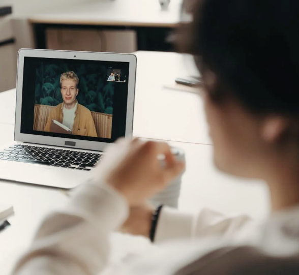 Person using laptop for remote video call during a BYOD meeting session