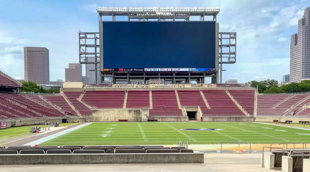 Massive LED display screen overlooking empty stadium field designed for high visibility and crowd engagement